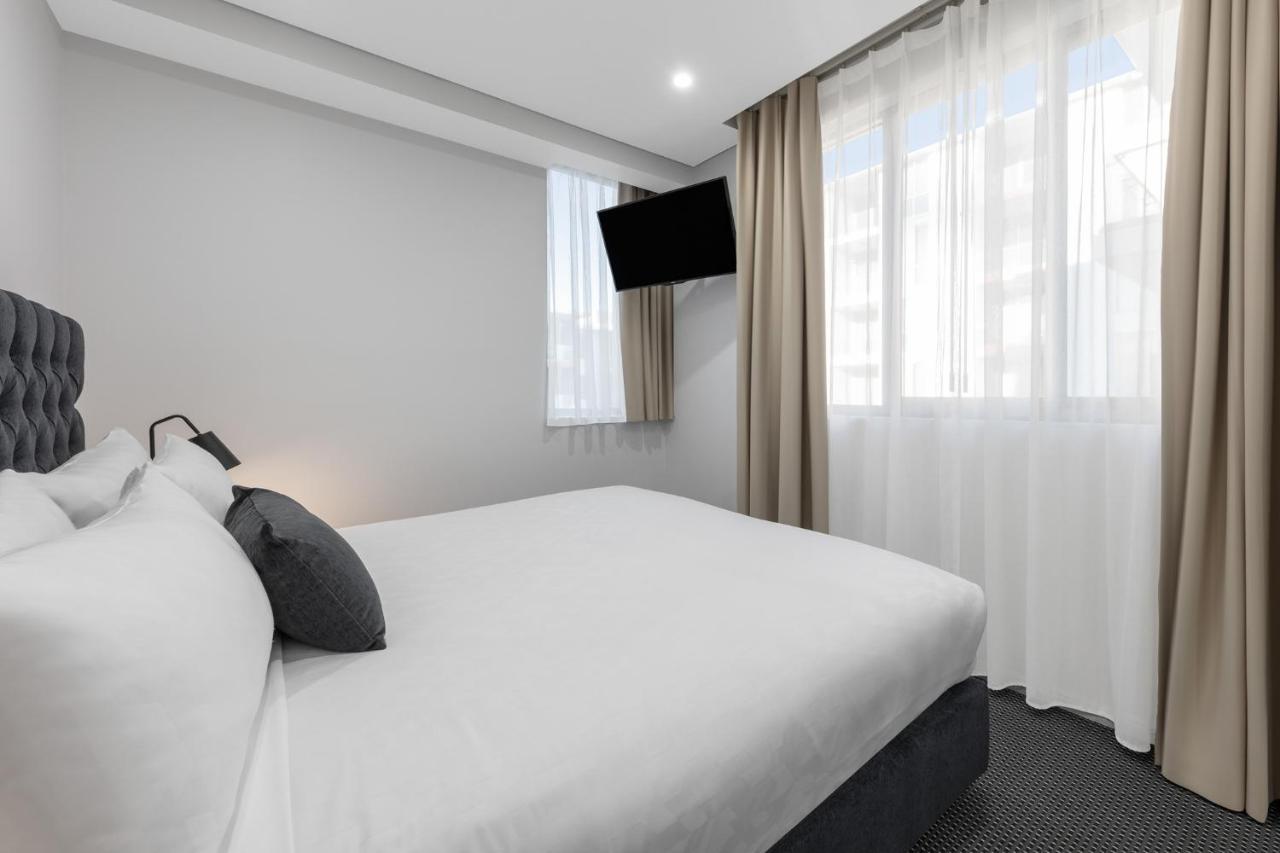 Meriton Suites North Ryde Cité de Cité de Sydney Extérieur photo A bedroom at the hotel