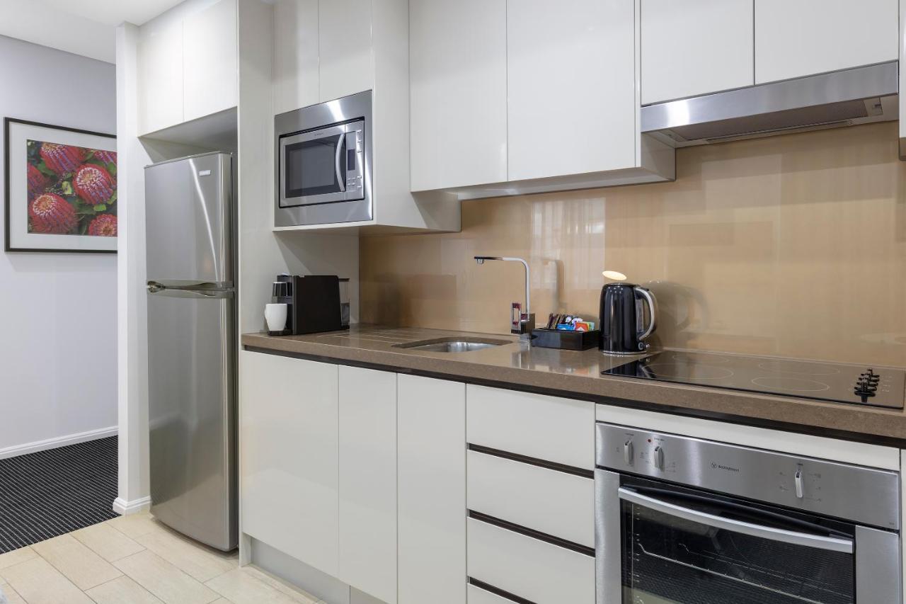 Meriton Suites North Ryde Cité de Cité de Sydney Extérieur photo A typical kitchen in a serviced apartment